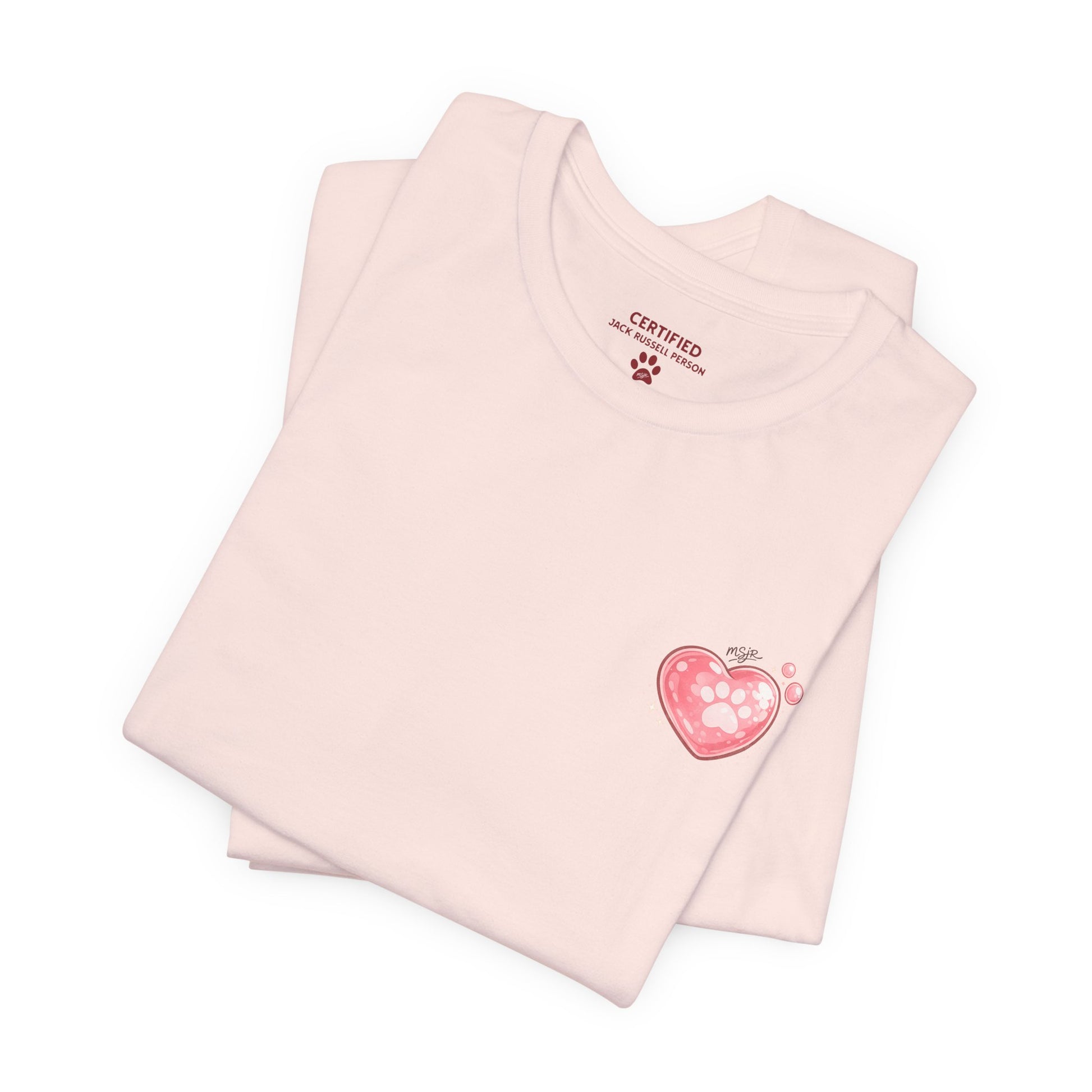 Folded soft pink Jack Russell Terrier t-shirt with small heart logo on front